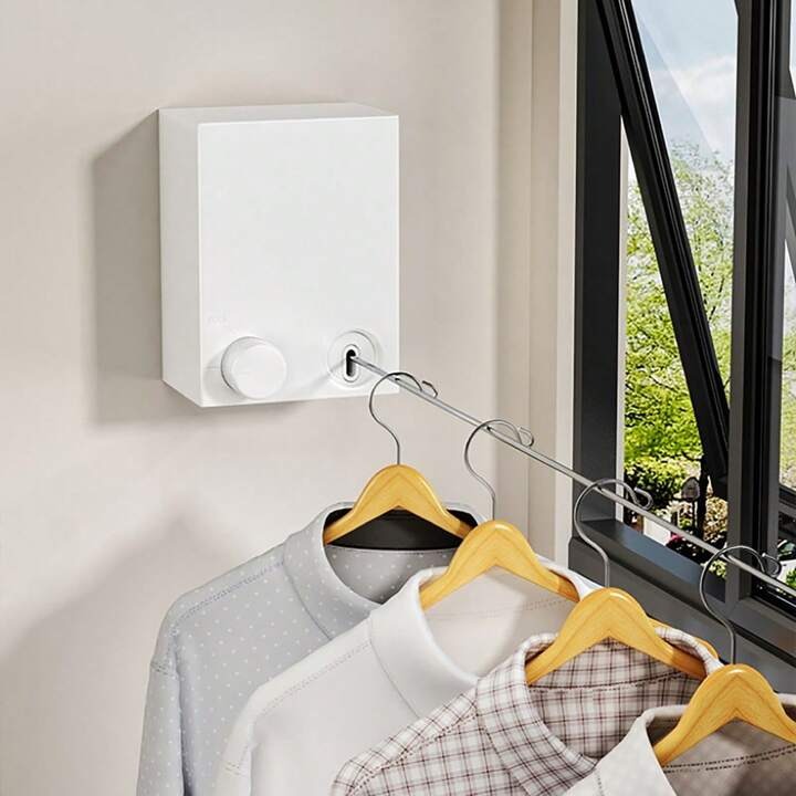 Retractable steel rope clothesline extended between two walls for drying clothes